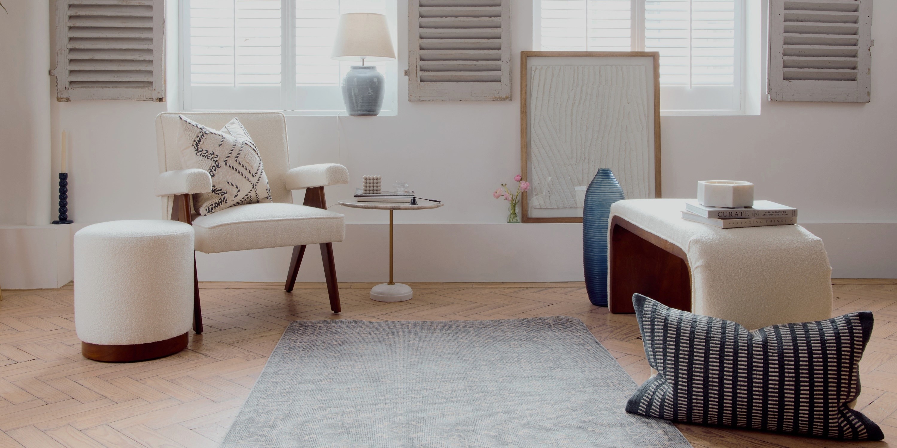 Picture of a living-room with a sofa, armchair, cushions and decorative accessories