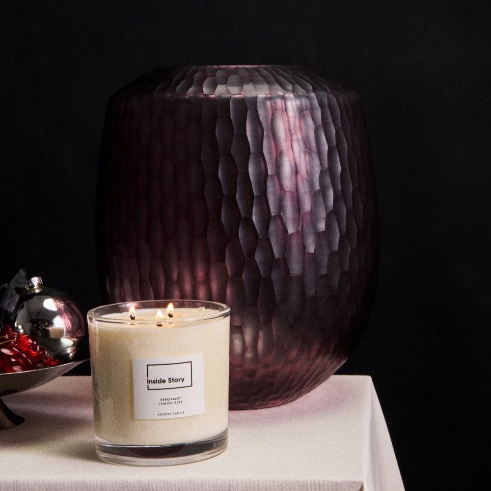 Vase next to a lemon zest candle with dark background