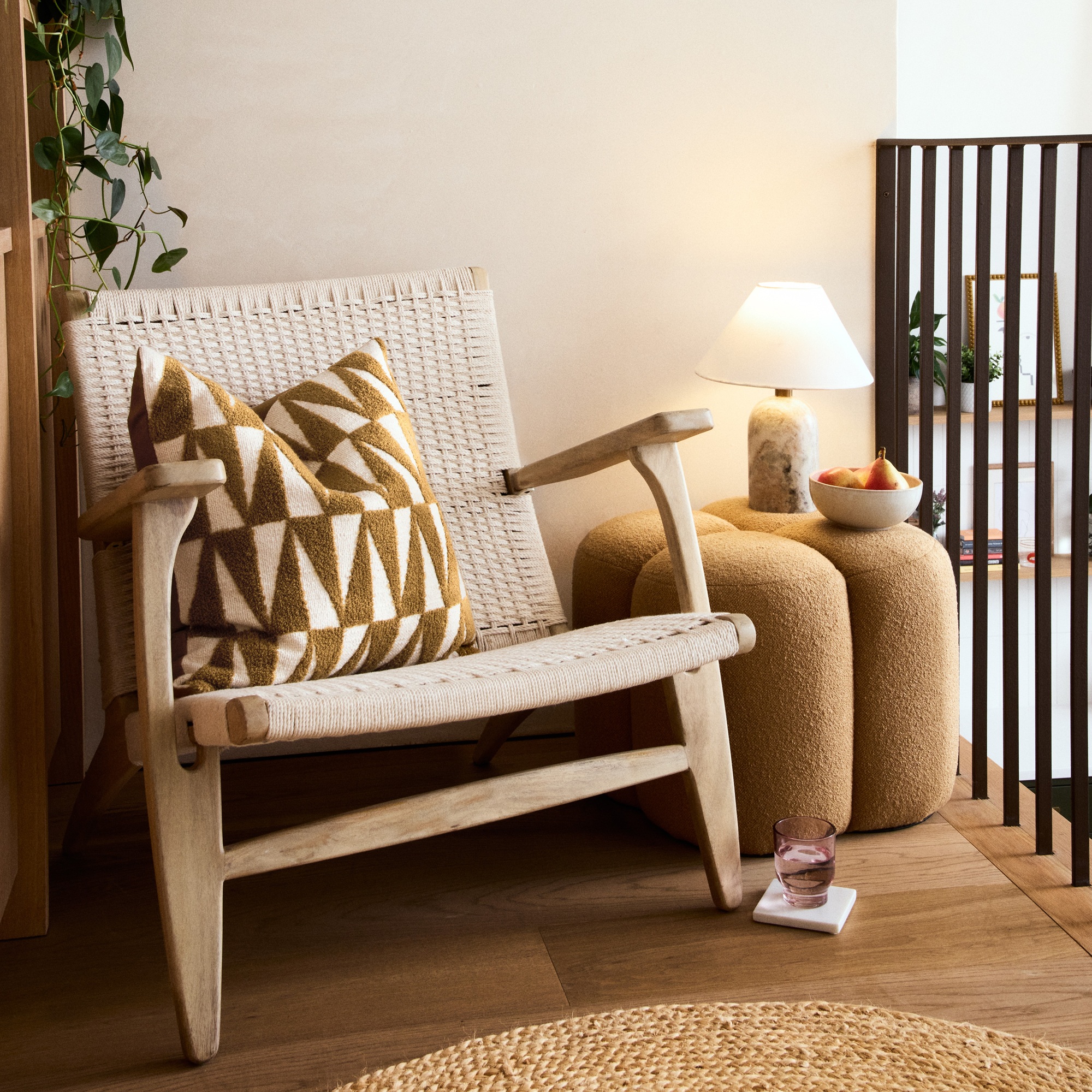 A wooden chair with a mustard geometric cushion