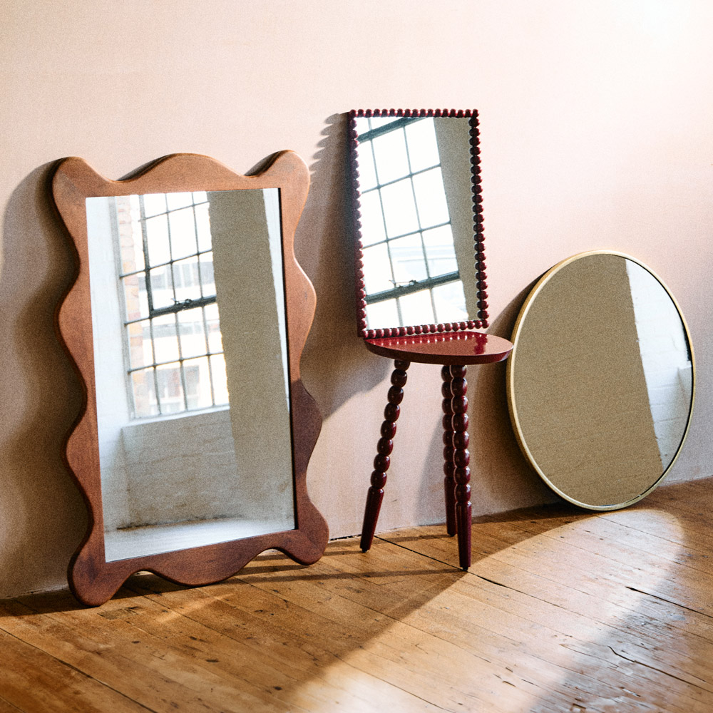A selection of mirrors leaning against a wall