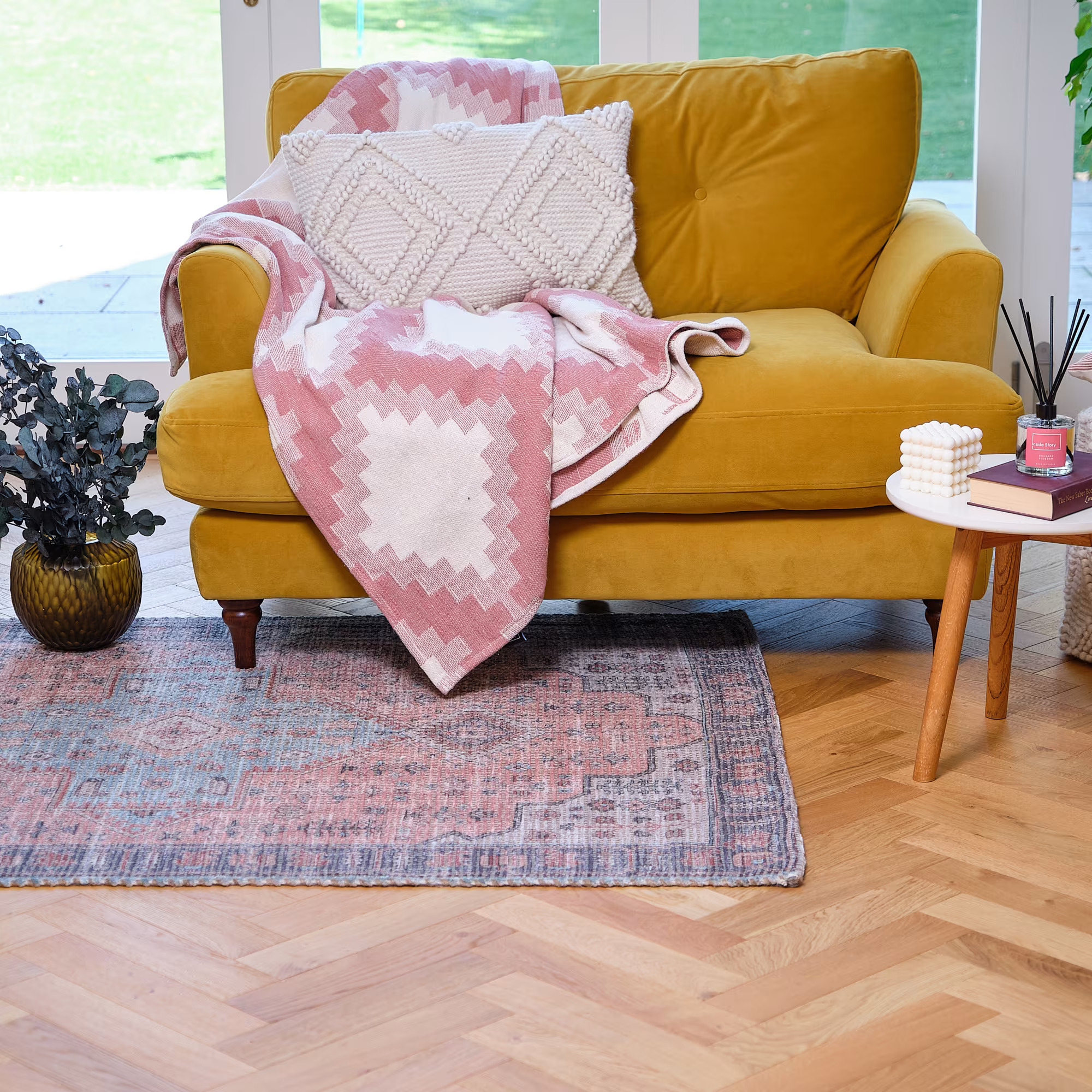 A bright living space with a chair and complementary rug