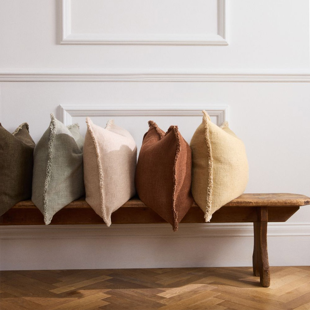 A variety of cushions on a bench