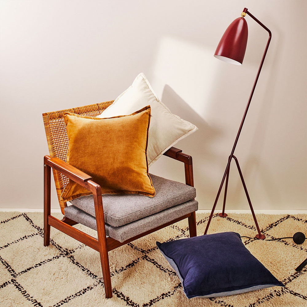 A range of bold coloured cushions on a chair