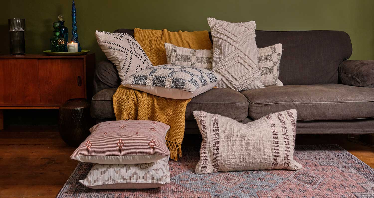 Cosy image of a woven throw in front of festive lights