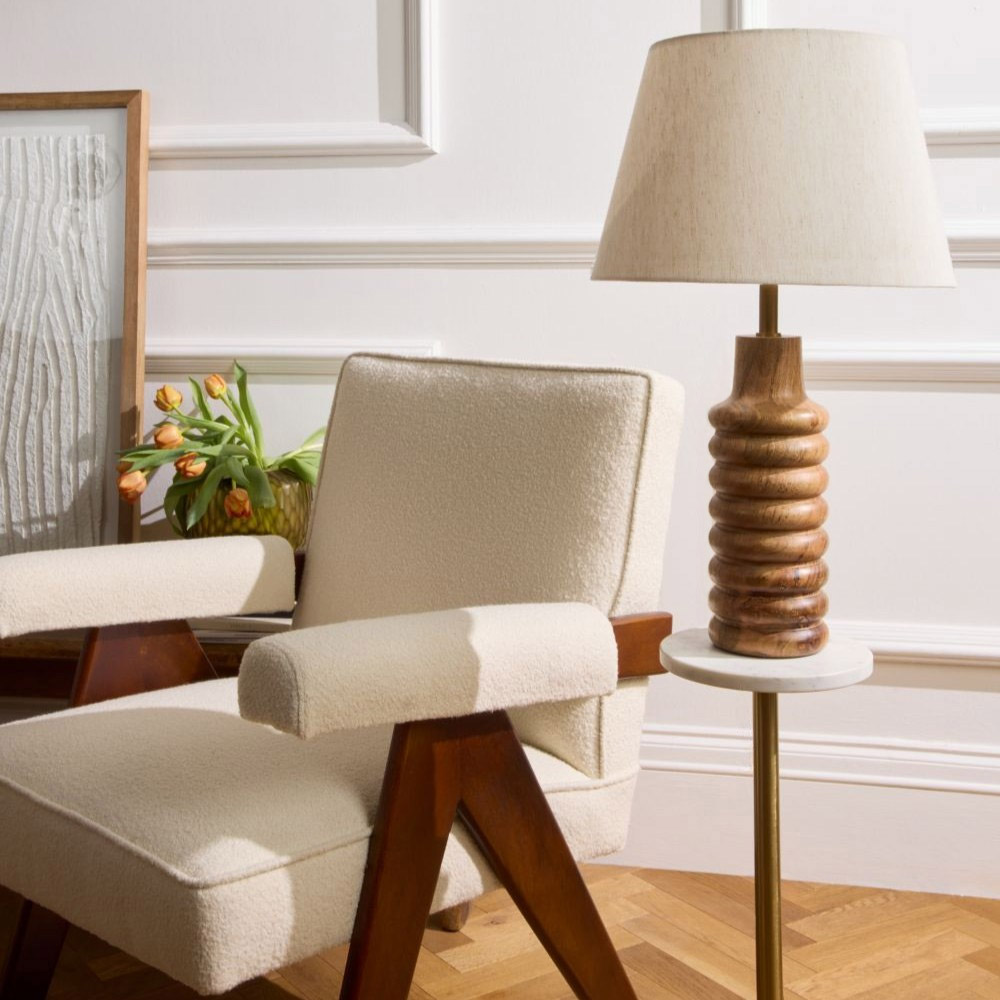 A Chair next to a lamp on a side table