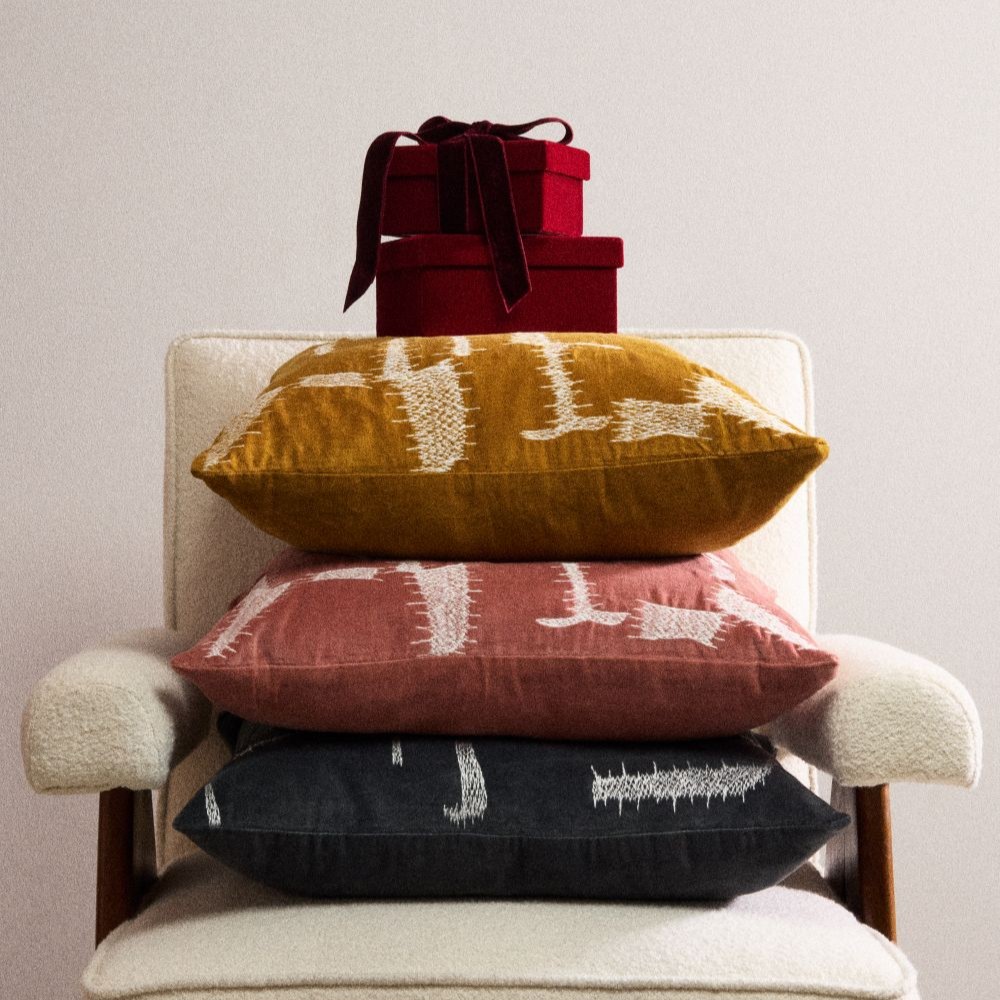 A wooden chair with a mustard geometric cushion