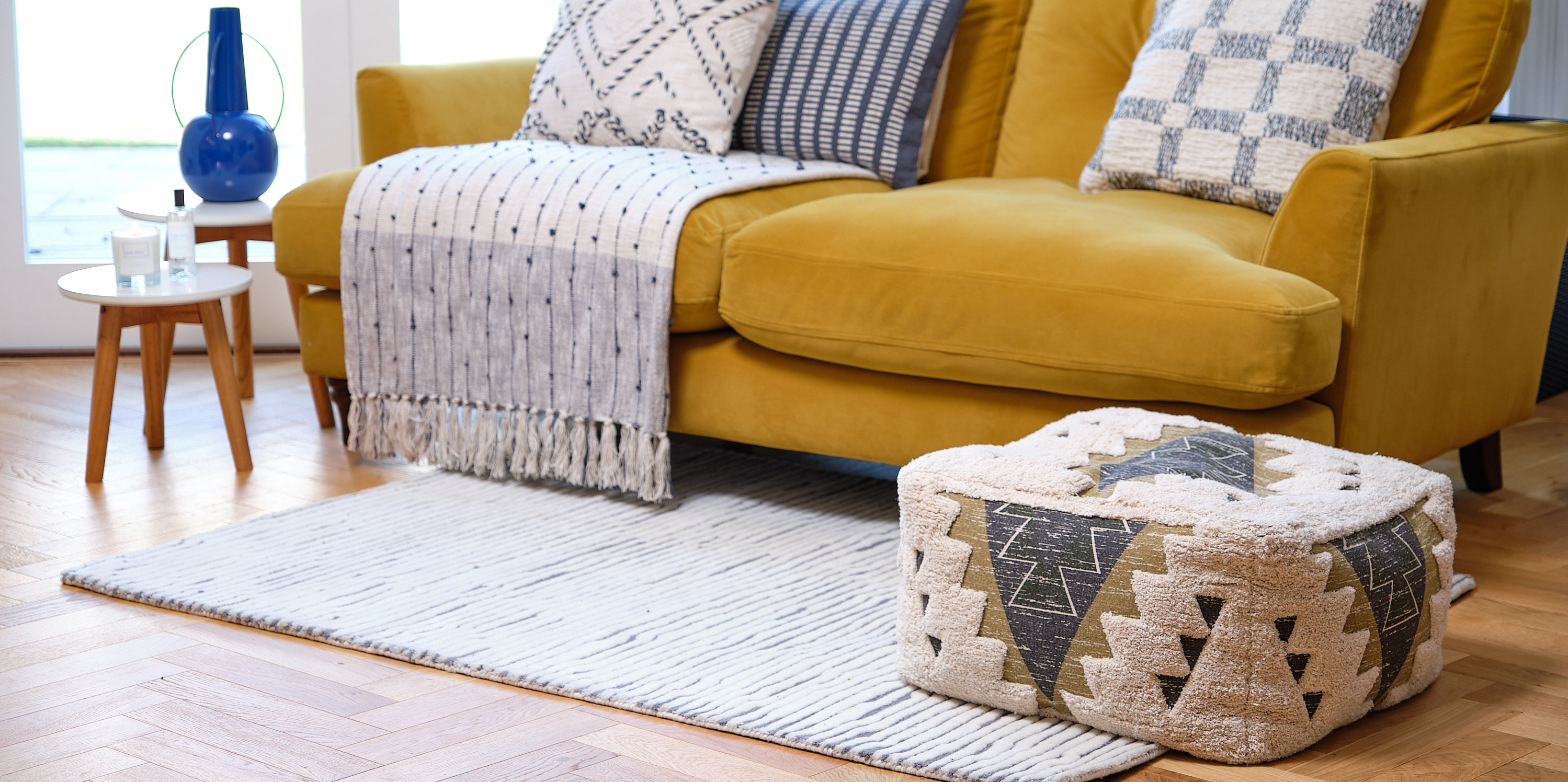 Bright Living Room with a striped navy and neutral rug and accessories